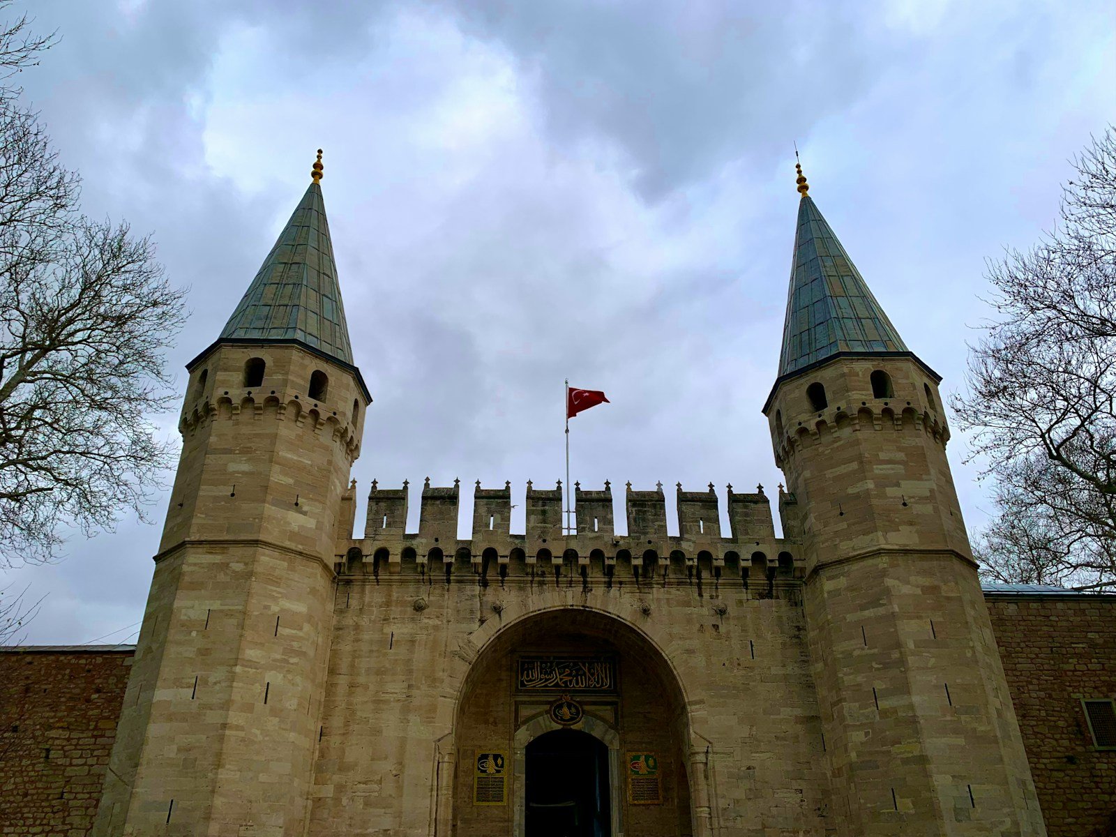 a castle with two towers and a flag on top